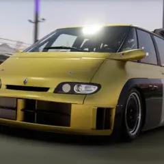 Żółty Renault Espace F1 z potężnym spojlerem i szerokimi wlotami powietrza pędzi po torze wyścigowym.