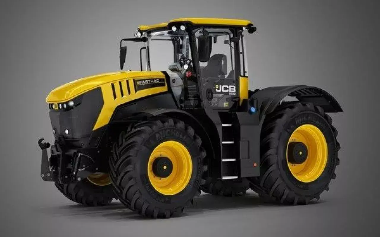 Potężny, żółto-czarny traktor JCB Fastrac z dużymi, terenowymi oponami i żółtymi felgami, gotowy do pracy na polu.